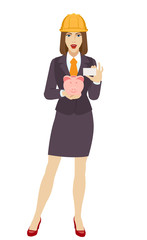 Businesswoman in construction helmet holding a piggy bank and showing the business card