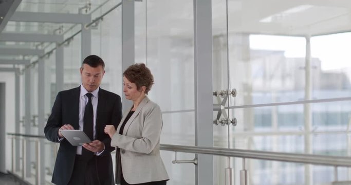 Business people having meeting in modern office using digital tablet