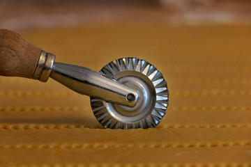 Cutter wheel on a layer of puff pastry