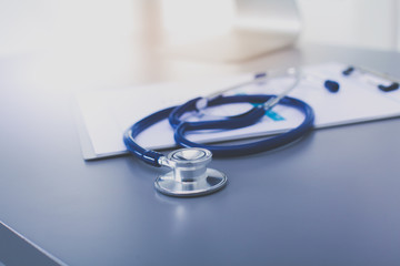 Medical equipment: blue stethoscope and tablet on white background. Medical equipment