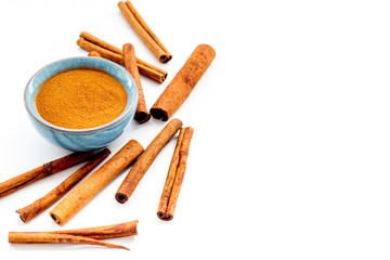 Cinnamon seasoning. Sticks and powder on white background copy space