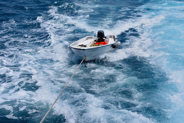 Fototapeta premium empty boat on a rope in the open sea