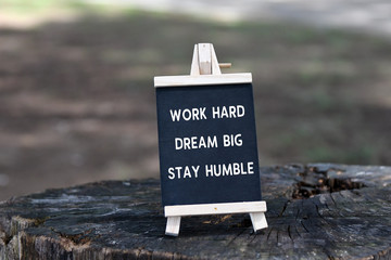 Inspirational quote - Work hard, dream big, stay humble, on black board.