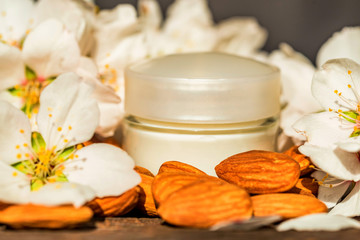 Almonds, face cream and white flowers