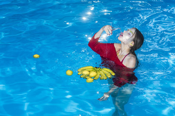 Vitamin in banana at girl sitting near water. Woman relax in spa pool. Summer vacation and travel to ocean. Dieting and healthy organic food, vegetarian. woman with tropical fruit in pool.