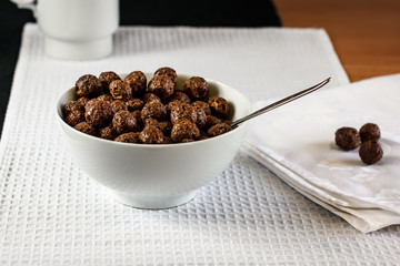 Cereal. Cocoa balls with milk for breakfast..