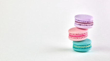 multicolored macaroons on a light background