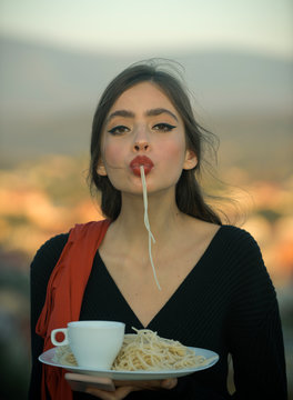 Chef woman with red lips eat pasta and drink coffee. chef, tasty breacfast or dinner with pasta and tea