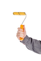 Paint roller with a orange color handle in the human hand