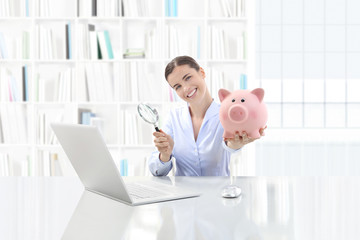 low cost and saving search concept, smiling woman working at office desk on computer with magnifying glass and piggy bank