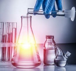 Different laboratory beakers and glassware. Chemical test in process.