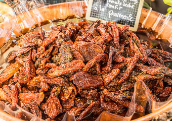 Dried tomatoes in the wooden bowl.