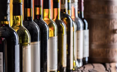 Küchenrückwand glas motiv Wine bottles in row and oak wine keg. © volff