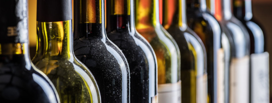 Line of wine bottles. Close-up.
