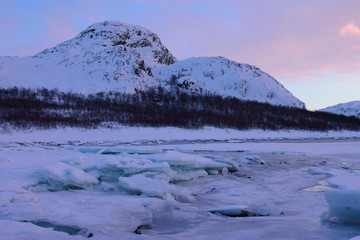 The coastline of the Barents Sea in the winter evening. Nature landscape. Kola peninsula, Russia.