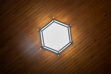 hexagonal lamp on the wooden ceiling.