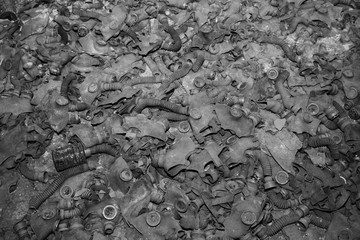 Gas masks  covering the floor of a abandoned building in Pripyat in Chernobyl Exclusion Zone,...