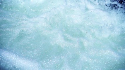 SLOW MOTION: flowing water over stones in mountain river