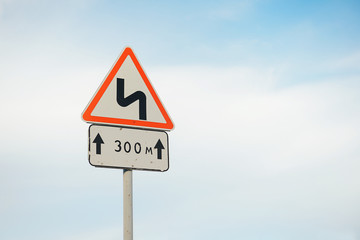 road sign curve road on blue sky background.