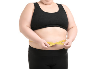 Overweight woman with measuring tape on white background