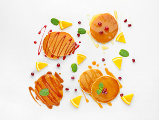 Delicious pancakes with fruits and jam on white background