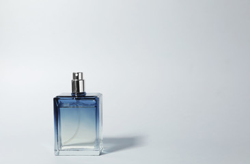 Bottle of perfume on light background