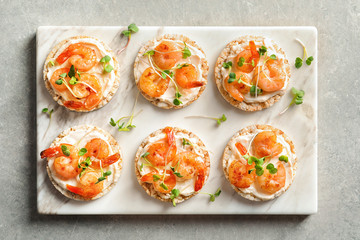 Delicious small sandwiches with shrimps on marble board