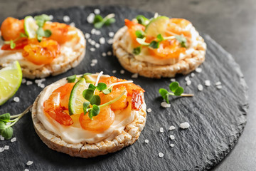 Delicious small sandwiches with shrimps on slate plate