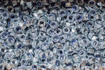 A huge pile of new metal nuts.
