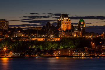 Fototapeta na wymiar City skyline of Quebec, Canada. Illuminated buildings against the evening sky.