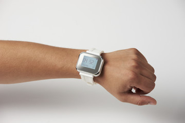 Naked male hand with smart wristwatch and digital clock on the screen on a white background, close-up