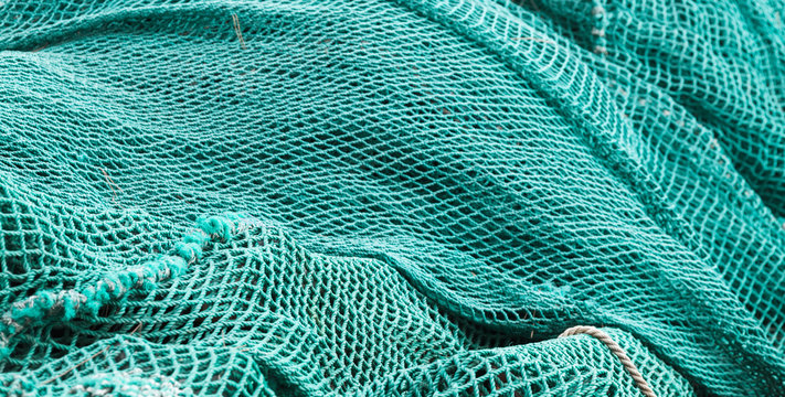 Drying green fishing net, background photo