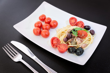 Spaghetti with Mediterranean tuna, capers, olives, Sicilian chilli pepper, cherry tomatoes and a sprinkling of parsley