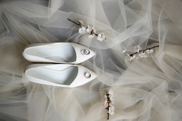 wedding rings and shoes on wedding morning of the bride