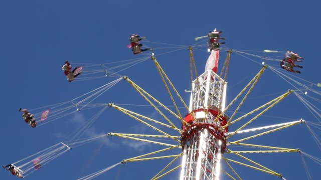 Flying swing carousel. Blue sky in the background.