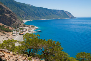Fototapeta na wymiar Agia Roumeli beach in Chania of Crete, Greece. The village of Agia Roumeli is located at the entrance of the gorge Samaria