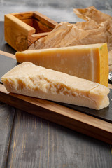 Aged Italian parmesan hard cheese Parmigiano-Reggiano with cheese knife