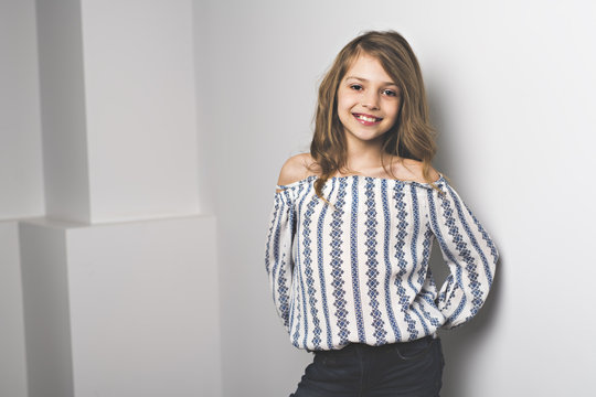 Portrait of 9 years old girl, isolated on gray