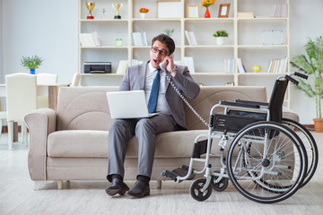 Dsabled businessman on wheelchair working home