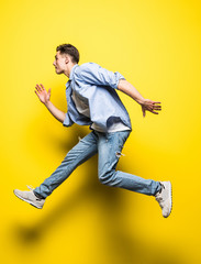 Fototapeta na wymiar Young handsome man jumping on yellow background. Jump, freedom, summer.