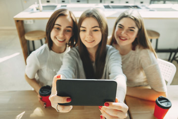 Three young women having fun and taking selfie