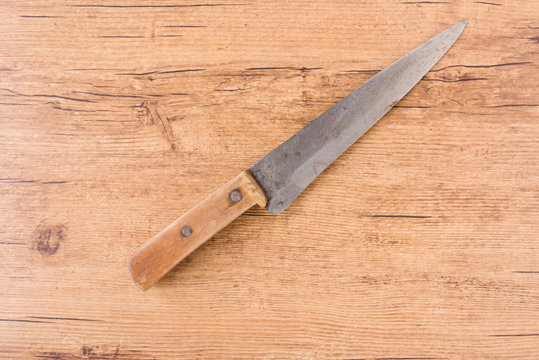old knife on wood background