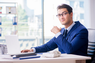 Fototapeta na wymiar Young handsome businessman employee working in office at desk