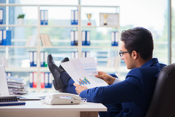 Fototapeta premium Young handsome businessman employee working in office at desk