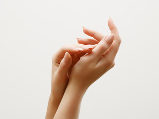 Hand skin care. Closeup of beautiful woman hands with light manicure on nails. Cream for hands and treatment.