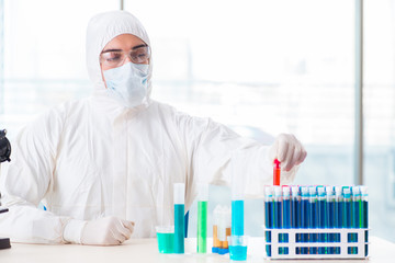 Young chemist student working in lab on chemicals