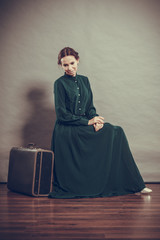 Woman retro style with old suitcase