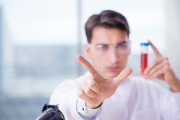 Man doctor checking blood samples in lab