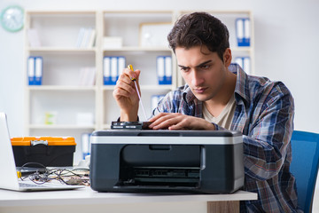 Hardware repairman repairing broken printer fax machine