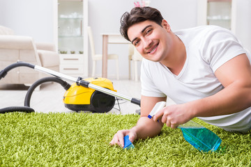 Young husband man cleaning floor at home